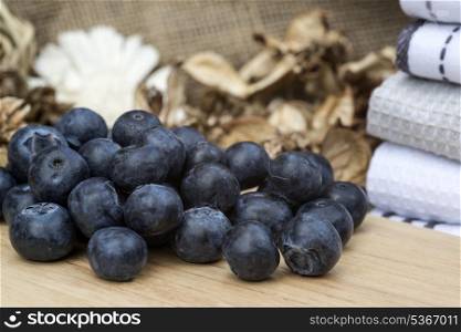 Fresh Summer blueberries on rustic wooden background. Macro image of fresh Summer blueberries