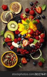 fresh summer fruits and berries on plate, above, rustic background