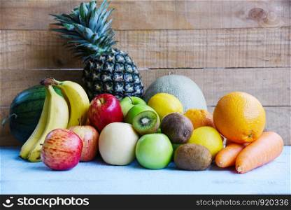 Fresh summer fruits on wooden table background / mix of fruits