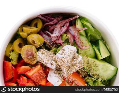 Fresh summer vegetable salad with lettuce, tomato, cucumber, bell pepper, onion and feta cheese