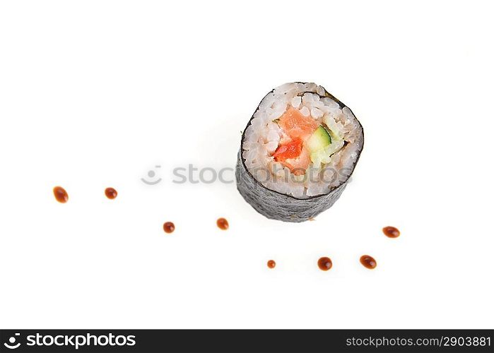 fresh sushi rolls and drop of sauce on table