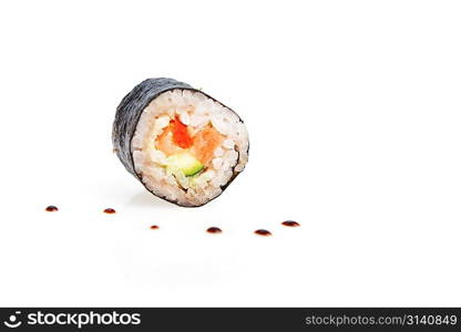 fresh sushi rolls and drop of sauce on table