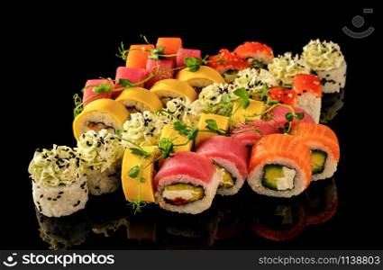 Fresh Sushi rolls set served on black background. Japanese seafood sushi.