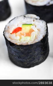 fresh sushi rolls with salmon on white background