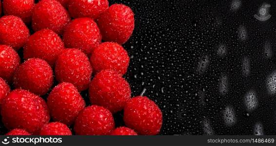 Fresh sweet raspberries close up on black background. Blured background macro. Copy space, Selective focus. Fresh sweet raspberries close up on black background. Blured background macro. Copy space