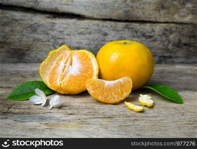 Fresh tangerines on grunge wooden background