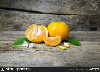 Fresh tangerines on grunge wooden background