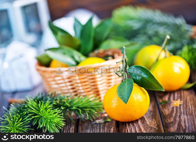 fresh tangerines with christmas decoration on a table