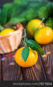 fresh tangerines with christmas decoration on a table