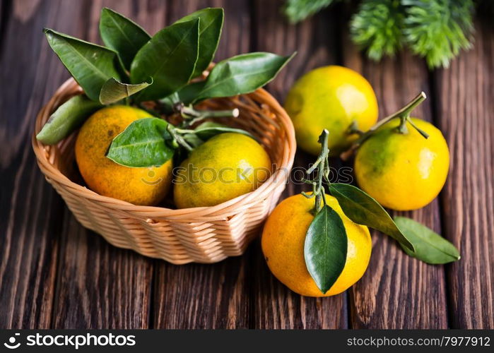 fresh tangerines with christmas decoration on a table