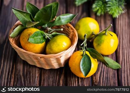 fresh tangerines with christmas decoration on a table