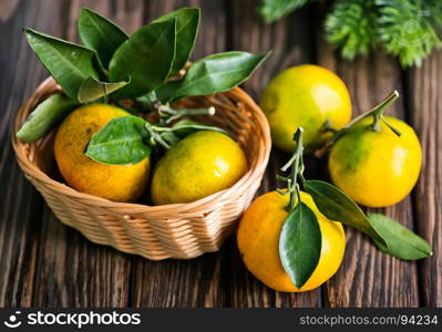 fresh tangerines with christmas decoration on a table