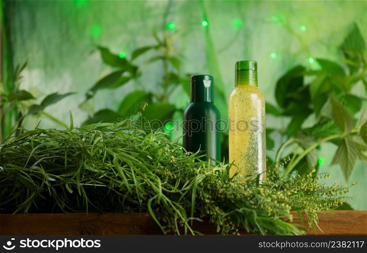 Fresh tarragon branches and tarragon oil. Bottle of tarragon herbs. Bottle with tarragon oil. Fresh green tarragon and essential oil
