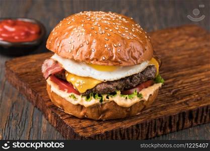 fresh tasty burger on wood table. Burger on a wooden board