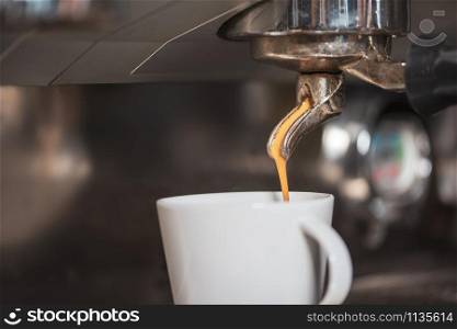 Fresh tasty coffee in white mug served from coffee machine. fresh tasty coffee