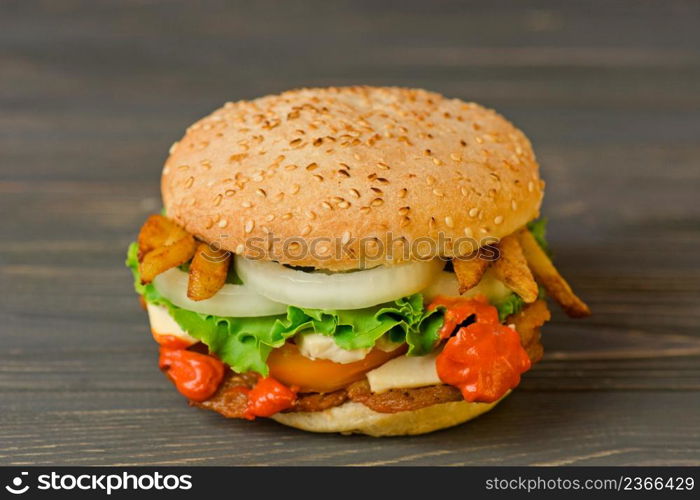 Fresh tasty homemade burger on wooden board. Delicious fresh burger