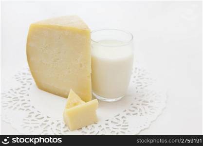 Fresh tasty piece of cheese and cup of milk