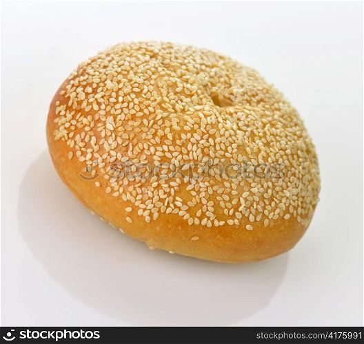 Fresh tasty roll with sesame, on white background