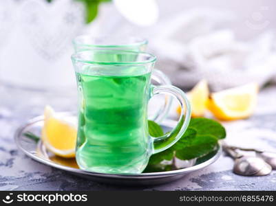 fresh tea in glass cups and on a table