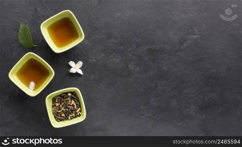 fresh tea with dried herb jasmine flower black surface