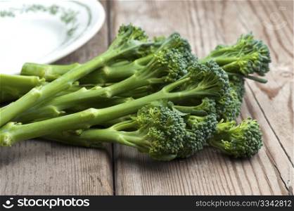 Fresh Tenderstem Broccoli Laid On A Wooden Kitchen Table