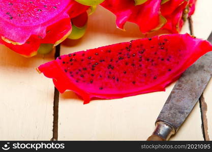 fresh thai purple dragon fruit over white rustic table