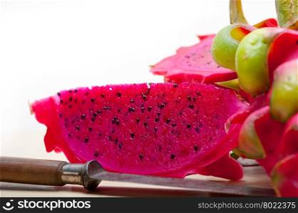 fresh thai purple dragon fruit over white rustic table