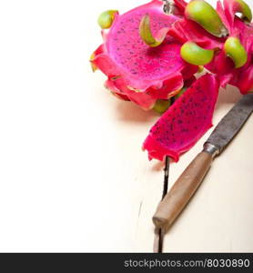 fresh thai purple dragon fruit over white rustic table