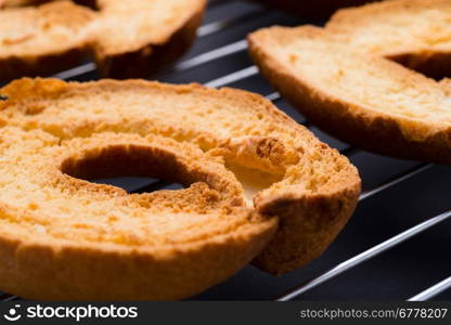 Fresh toasted bagels. Bread and bakery: fresh roasted bagels on a grill, close-up shot, dark table surface on background