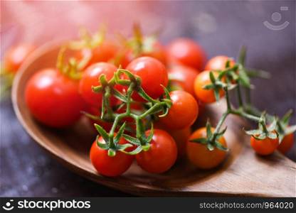 Fresh tomato cherry organic / Close up ripe red tomatoes wooden spoon background - selective focus