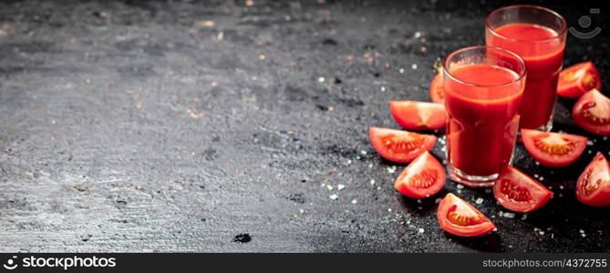 Fresh tomato juice. On a black background. High quality photo. Fresh tomato juice. On a black background.