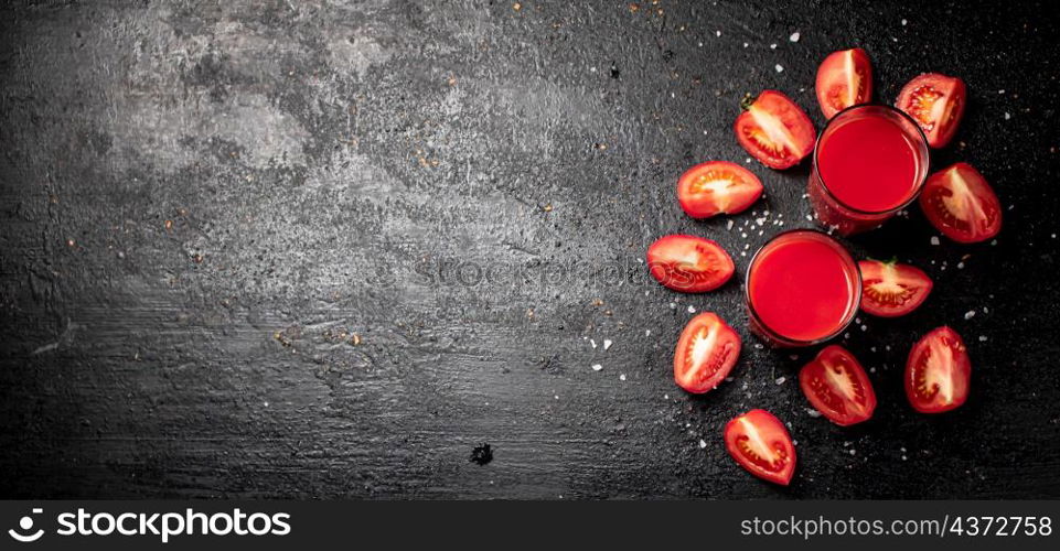 Fresh tomato juice. On a black background. High quality photo. Fresh tomato juice. On a black background.