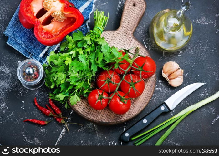 fresh tomato on board and on a table