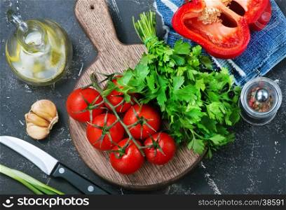 fresh tomato on board and on a table