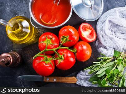fresh tomato soup and tomato on kitchen table