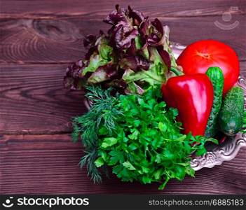 fresh tomato vegetables, red pepper and parsley on an iron plate