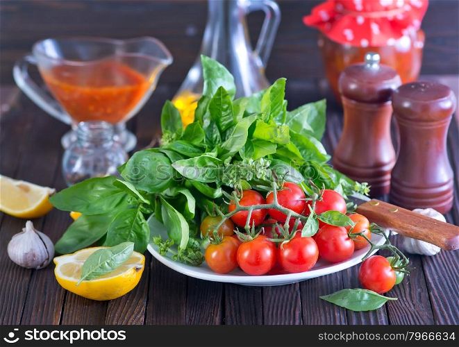 fresh tomato with basil on board and on a table