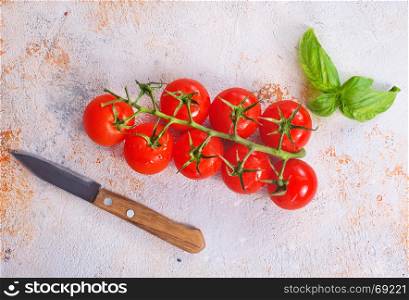 fresh tomato with green basil on a table