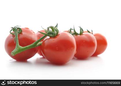 fresh tomatoes covered with drops isolated on white background