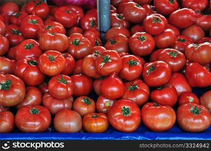 Fresh tomatoes for sale at grocery store. Vegetables background.