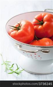 fresh tomatoes in colander