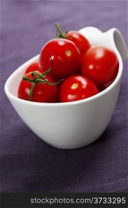 fresh tomatoes in white bowl
