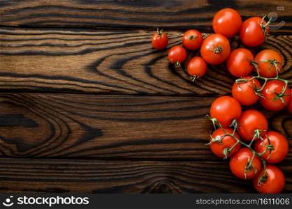 Fresh tomatoes isolated on wooden background, top view. Organic vegetarian food, grocery assortment, natural eco products, healthy lifestyle concept. Fresh tomatoes isolated on wooden background