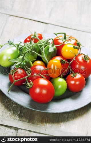 Fresh tomatoes on a wooden table top