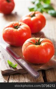 fresh tomatoes on cutting board