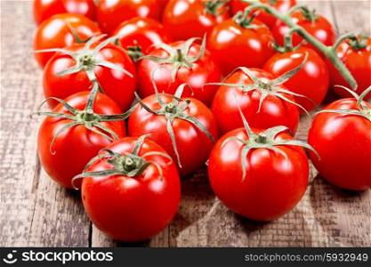 fresh tomatoes on wooden table