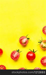 Fresh tomatoes, whole and half cut isolated on yellow background. Top view