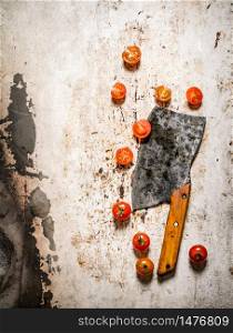 Fresh tomatoes with an old knife. On rustic background.. Fresh tomatoes with an old knife.