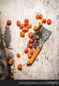 Fresh tomatoes with an old knife. On rustic background.. Fresh tomatoes with an old knife.