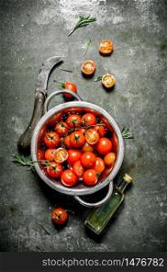 Fresh tomatoes with olive oil and a knife. Wet stone background. . Fresh tomatoes with olive oil and a knife.